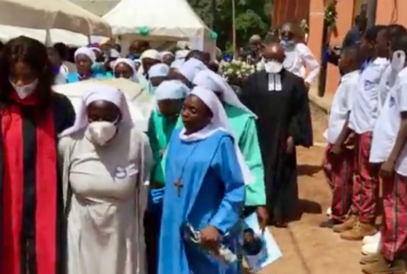 Sister Jane Mankaa's casket is carried to her final resting place on convent grounds