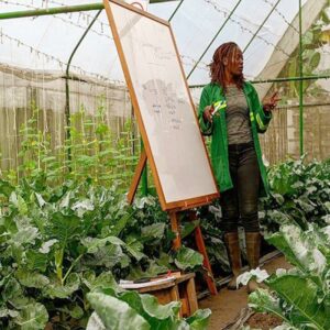 a trainer teaching within the greenhouse